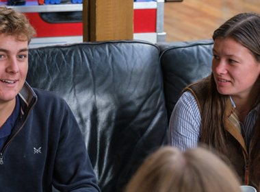 Two students sat on sofa chatting